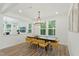 Sunlit dining room featuring a modern chandelier and an inviting wood dining table at 187 Harpers Landing Rd, Garner, NC 27529
