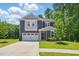 Charming two-story home features a well-manicured lawn and an attached two-car garage at 187 Harpers Landing Rd, Garner, NC 27529