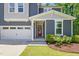 Close up of a beautiful home featuring a striking red front door and attached two-car garage at 187 Harpers Landing Rd, Garner, NC 27529