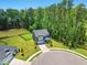 Charming gray home featuring manicured lawn and a backdrop of mature trees at 187 Harpers Landing Rd, Garner, NC 27529