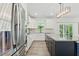 Bright kitchen features white cabinets, a large island, stainless steel appliances, and modern lighting at 187 Harpers Landing Rd, Garner, NC 27529