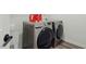 Modern laundry room equipped with a sink and updated washer and dryer, perfect for convenient home care at 187 Harpers Landing Rd, Garner, NC 27529