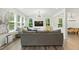 Sun-filled living room features large windows, neutral furniture, and an open layout at 187 Harpers Landing Rd, Garner, NC 27529