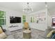 Bright living room featuring stylish furniture and abundant natural light through large windows at 187 Harpers Landing Rd, Garner, NC 27529