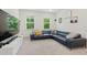 Spacious living room featuring a dark sectional sofa, media center, and natural light at 187 Harpers Landing Rd, Garner, NC 27529