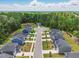 New construction homes line a well-manicured street with lush greenery and blue skies at 187 Harpers Landing Rd, Garner, NC 27529