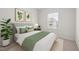 A bright bedroom featuring a bed with green accents, modern décor and natural light at 209 Timber Forest Ln, Cary, NC 27519