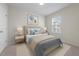 A bright bedroom featuring a bed with blue accents, modern décor and natural light at 209 Timber Forest Ln, Cary, NC 27519