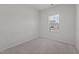 A clean bedroom featuring carpet, a window and neutral walls at 209 Timber Forest Ln, Cary, NC 27519