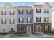 Charming townhome showcases varied exterior finishes and colors, with stone accents and well-maintained landscaping at 209 Timber Forest Ln, Cary, NC 27519