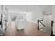 Bright, modern kitchen with a white island, stainless appliances, and a sliding glass door to the outside at 209 Timber Forest Ln, Cary, NC 27519