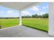 Covered back patio with a view of the lush green lawn at 210 Bluebell St, Sanford, NC 27330