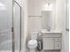 Bright, clean bathroom featuring a glass-enclosed shower and neutral finishes at 210 Bluebell St, Sanford, NC 27330