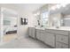 Bright bathroom featuring double sinks with white cabinetry, natural light, and neutral colors at 210 Bluebell St, Sanford, NC 27330