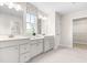 Bathroom with dual vanity sinks, neutral finishes, tile floors, and natural light at 210 Bluebell St, Sanford, NC 27330