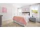 Bright bedroom featuring soft pink accents, carpet flooring, and a window view at 210 Bluebell St, Sanford, NC 27330