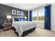 Cozy bedroom with a large window providing natural light, and a dark accent wall at 210 Bluebell St, Sanford, NC 27330