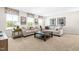 This loft features neutral decor, comfortable seating, and large bright windows at 210 Bluebell St, Sanford, NC 27330