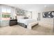 Bright main bedroom featuring neutral colors, soft carpet, and large windows with a view at 210 Bluebell St, Sanford, NC 27330