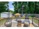 Backyard deck with table and chairs under umbrella, barbecue and fire pit at 212 Southerby Dr, Garner, NC 27529