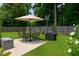 Backyard with well-manicured lawn with chairs, table, barbecue and storage box at 212 Southerby Dr, Garner, NC 27529