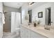 Bright bathroom featuring double vanity sinks, framed mirror, shower and tile flooring at 212 Southerby Dr, Garner, NC 27529