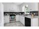 Bright kitchen with white cabinets, modern appliances, and an eye-catching backsplash at 212 Southerby Dr, Garner, NC 27529
