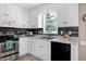 Well-equipped kitchen featuring white cabinets, stainless steel appliances, and stylish backsplash at 212 Southerby Dr, Garner, NC 27529