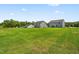 Large backyards behind multiple newly constructed homes in a pristine community on a sunny day at 214 Bluebell St, Sanford, NC 27330