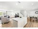 Open-concept living space featuring a kitchen island, dining area, and comfortable seating at 214 Bluebell St, Sanford, NC 27330