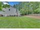 Spacious backyard features a patio, grill, and manicured lawn, perfect for entertaining at 2310 Turning Pointe Way, Hillsborough, NC 27278