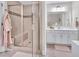 Bright bathroom featuring a glass shower with a built-in bench and a double sink vanity with a large mirror at 2310 Turning Pointe Way, Hillsborough, NC 27278