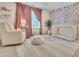 Charming Bedroom with floral wallpaper, a crib, a rocking chair, and soft pink accents creating a cozy atmosphere at 2310 Turning Pointe Way, Hillsborough, NC 27278