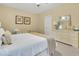 Well-lit bedroom showcasing a queen bed, dresser, and inviting decor at 2310 Turning Pointe Way, Hillsborough, NC 27278