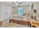 Comfortable bedroom features a large bed, neutral decor, double closets and a ceiling fan for added comfort at 2310 Turning Pointe Way, Hillsborough, NC 27278