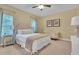 Bright bedroom featuring a queen bed, neutral walls, and decorative sitting area at 2310 Turning Pointe Way, Hillsborough, NC 27278