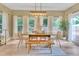 Bright dining room with wood table, stylish chairs, bench, and large windows for natural light at 2310 Turning Pointe Way, Hillsborough, NC 27278
