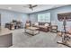 Spacious living room with a comfortable leather sofa, a desk area, and exercise equipment, blending relaxation and functionality at 2310 Turning Pointe Way, Hillsborough, NC 27278