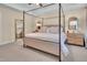 Spacious main bedroom with four-poster bed and neutral decor at 2310 Turning Pointe Way, Hillsborough, NC 27278
