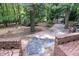 Spacious backyard with multiple mature trees and brick stairs at 26 Mt. Bolus Rd, Chapel Hill, NC 27514