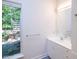 Bathroom with white cabinets, sink, and natural light from the window at 26 Mt. Bolus Rd, Chapel Hill, NC 27514