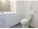 Bathroom with white cabinets, sink, toilet and tiled shower at 26 Mt. Bolus Rd, Chapel Hill, NC 27514