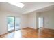 Bright bedroom featuring hardwood floors, skylight and sliding glass door at 26 Mt. Bolus Rd, Chapel Hill, NC 27514