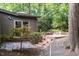 Home exterior with brick steps and lush greenery at 26 Mt. Bolus Rd, Chapel Hill, NC 27514