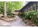 Attractive single story home surrounded by mature trees, featuring a stone walkway at 26 Mt. Bolus Rd, Chapel Hill, NC 27514