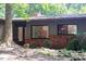 Charming single-story home with a brick accent, mature trees, and natural landscaping at 26 Mt. Bolus Rd, Chapel Hill, NC 27514