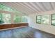 Bright sunroom featuring large windows, exposed brick and wood ceiling at 26 Mt. Bolus Rd, Chapel Hill, NC 27514