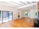 Living room with hardwood floors, vaulted ceilings, and sliding glass doors to the outside at 26 Mt. Bolus Rd, Chapel Hill, NC 27514