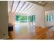 Bright living room with hardwood floors, white vaulted ceilings, and scenic backyard views at 26 Mt. Bolus Rd, Chapel Hill, NC 27514