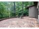 Spacious brick patio with mature trees at 26 Mt. Bolus Rd, Chapel Hill, NC 27514